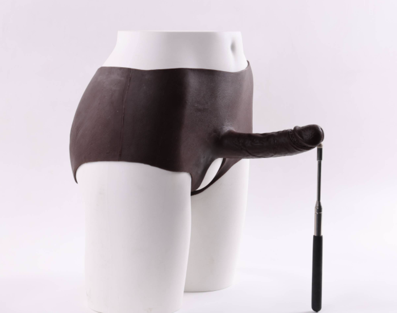 Mela (with cutouts) wearing a dildo