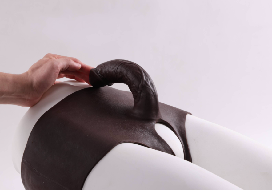 Mela (with cutouts) wearing a dildo