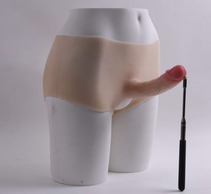 Mela (with cutouts) wearing a dildo